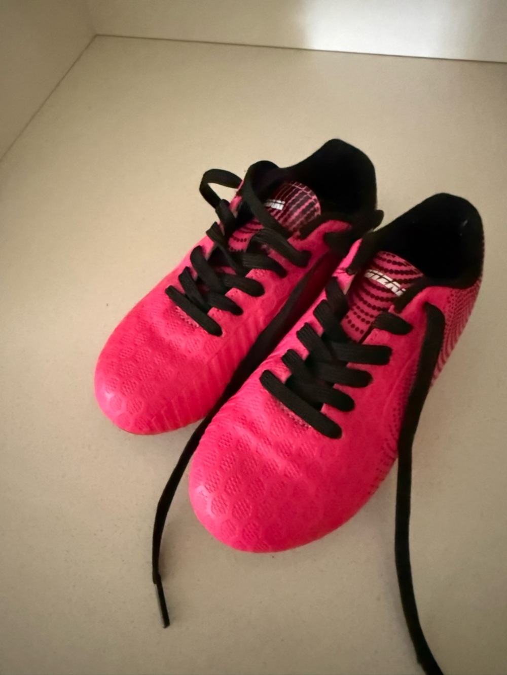 Pink soccer cleats with Black Accents